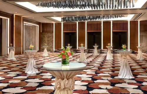 a large room with a table and flowers on it at Marco Polo Plaza Cebu in Cebu City