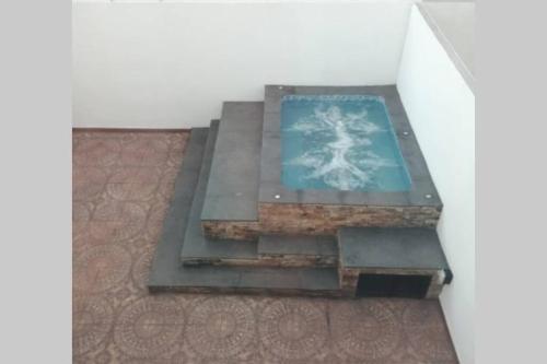 a glass table with a cross on top of it at Any Mood! casa de descanso con Jacuzzi climatizado in Oaxtepec
