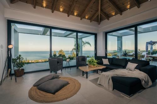 a living room with a couch and a table at Horizon luxury villa in Agios Nikolaos