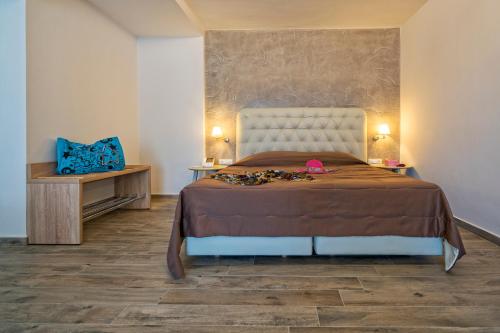 a bedroom with a large bed and two night stands at Lagomandra Beach Hotel in Lagomandra