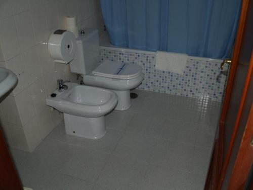 a bathroom with a toilet and a sink at Hostal Carlos III in El Ejido