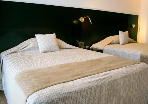 En eller flere senge i et værelse på Suites Terraza Imperial