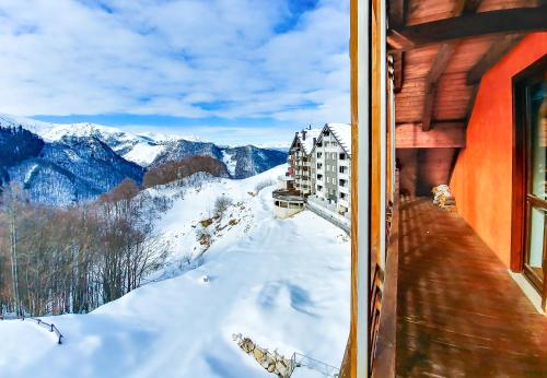 a view from a window of a snowy mountain at Borgo Stalle in Prato Nevoso