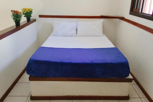 Una cama o camas en una habitación de Arco Iris Chalés I