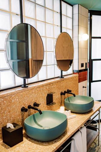 a bathroom with two sinks and a mirror at Stay at Hotel Steyne in Sydney