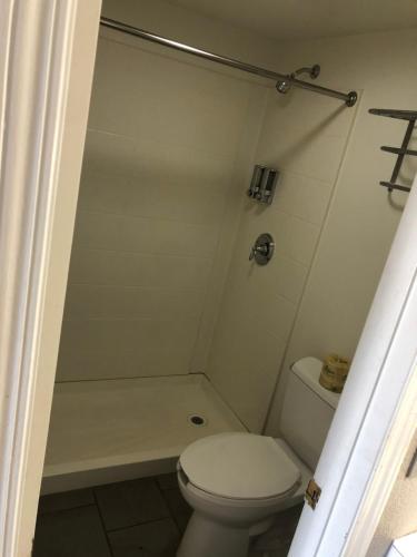 a white bathroom with a toilet and a shower at BestWay Inn Oklahoma City Airport in Oklahoma City