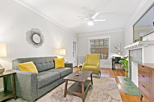 a living room with a couch and a table at Indulging 2BR Apartment in Festive Boystown - Buckingham 1 in Chicago