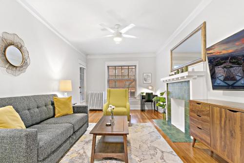 a living room with a couch and a tv at Indulging 2BR Apartment in Festive Boystown - Buckingham 1 in Chicago