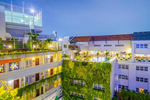an overhead view of buildings with plants on the roofs at Rex Hotel in Ho Chi Minh City