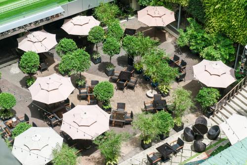 an overhead view of a patio with tables and umbrellas at Rex Hotel in Ho Chi Minh City