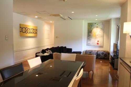 a living room with a table and a couch at The Ridge Hakuba Hotel & Apartments in Hakuba