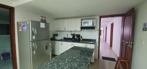 a kitchen with a stainless steel refrigerator and a counter at Edificio Sea View - Apartamento 303 B in San Andrés