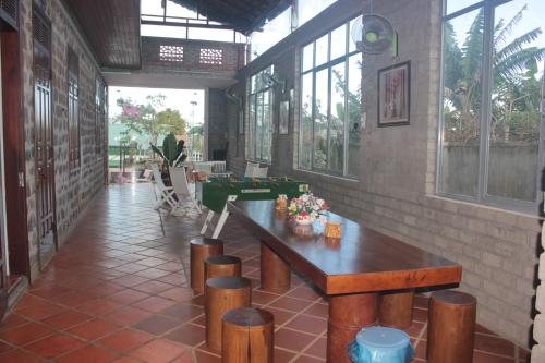 a room with a table and stools in a building at Gia lai Homestay Phương My in Pleiku