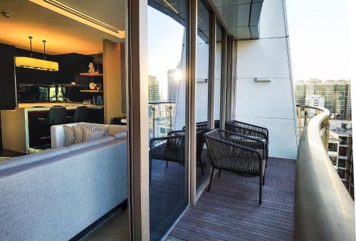 a balcony with a table and chairs on a building at Kempinski Residences Guangzhou - Free shuttle between hotel and Exhibition Center during Canton Fair & Exhibitor registration Counter in Guangzhou
