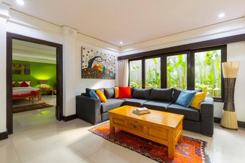 a living room with a couch and a coffee table at Villa Kibbi in Seminyak