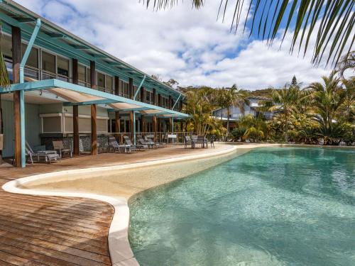 a resort with a swimming pool next to a building at Mobys 29 in Boomerang Beach