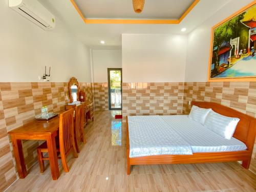 a bedroom with a bed and a table and a counter at Phu My Hung Bungalow in Phú Quốc