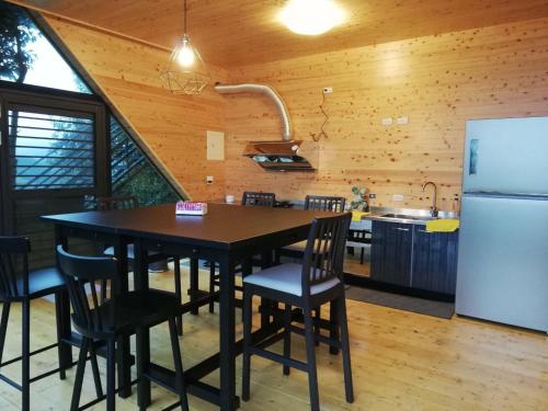 a kitchen with a table and chairs and a refrigerator at 深山林內民宿 in Zhushan