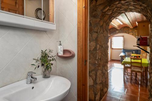 a bathroom with a sink and a stone wall at Finca Jabali in Tortosa