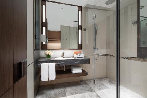 a bathroom with a sink and a shower at Crowne Plaza Shanghai Hongqiao by IHG in Shanghai