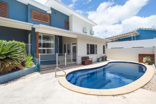 a large swimming pool in front of a house at Marina Beach Holiday Home in Cremorne