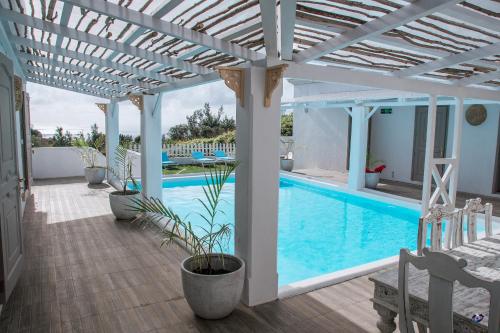 a house with a swimming pool with a pergola at Au Temps D'antan- Ile Rodrigues in Rodrigues Island