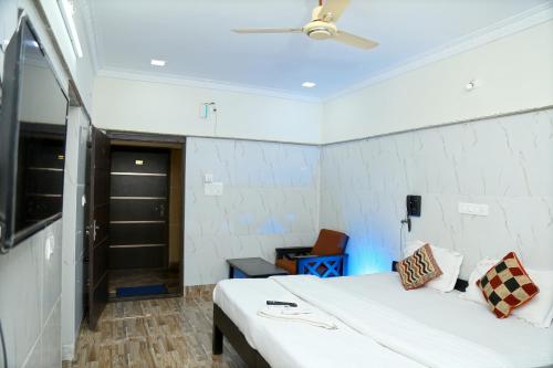 a bedroom with a bed and a ceiling fan at Lakeview Residency, Sricity TADA in Tada