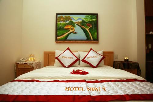 a bedroom with a bed with red and white pillows at Hotel Như ý Biên Hòa in Bien Hoa