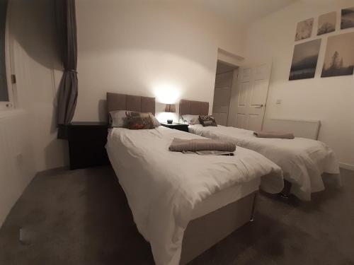 a room with three beds in a room at Carvetii - Edward House A - 2 Dbl bed 1st floor flat in Dunfermline