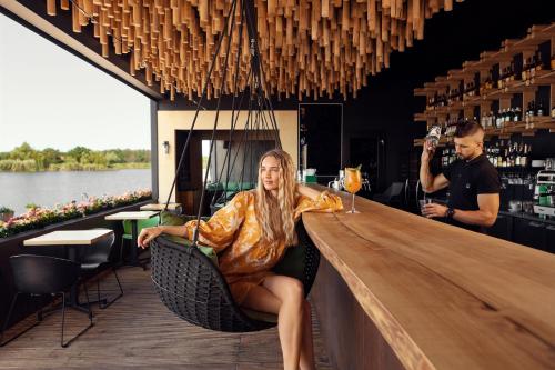 a man sitting in a chair at a bar at GOOD ZONE Hotel in Peschanka