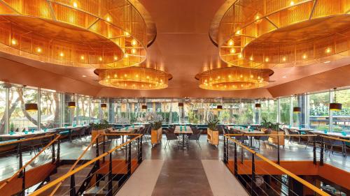 a large dining room with tables and chandeliers at GOOD ZONE Hotel in Peschanka