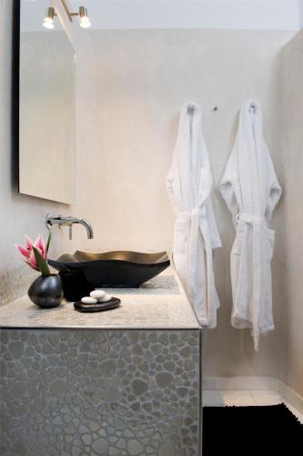 a bathroom with white towels hanging on a wall at Gold Suites - Small Luxury Hotels of the World in Imerovigli
