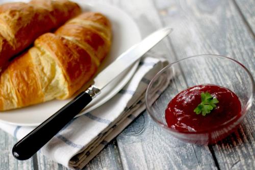 a plate with a loaf of bread and a bowl of fruit at Käringsund Resort in Eckerö