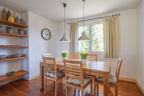 a dining room with a wooden table and chairs at Domaine d'Essendiéras in Saint-Médard-dʼExcideuil