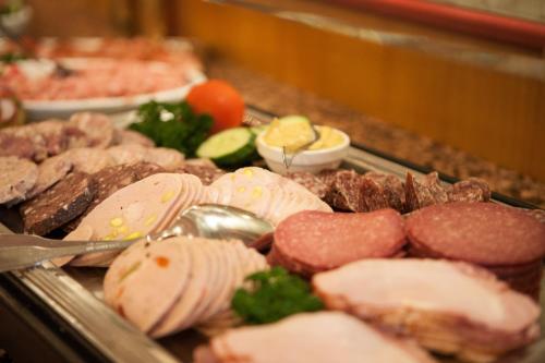 a bunch of different types of meat and vegetables at Hotel Restaurant Zur Post Lohfelden in Kassel