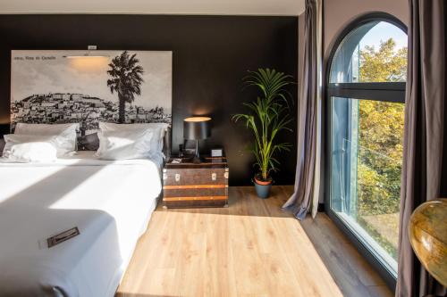 a bedroom with a bed and a large window at 138 Liberdade Hotel in Lisbon