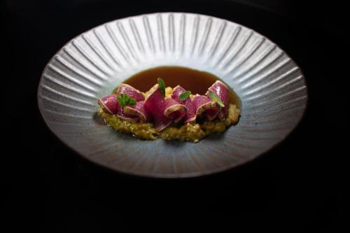 a piece of food on a paper plate at Kouros Exclusive Hotel & Suites - Adults Only in Faliraki