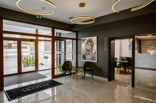 a lobby with chairs and a table in a building at Hotel Polonia in Biała Podlaska
