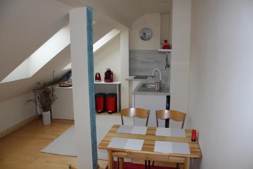 a kitchen and dining room with a table and chairs at RENMIR in Poprad