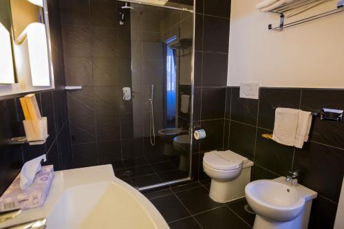 a bathroom with a sink and a toilet and a shower at Hotel Europa Art Caserta in Caserta