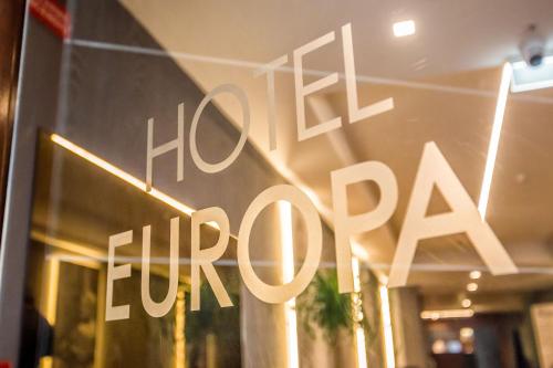 a sign in a store window that says hotel open at Hotel Europa Art Caserta in Caserta