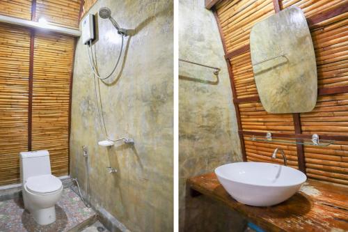a bathroom with a shower and a sink and a toilet at Lanta Wild Beach Resort in Ko Lanta