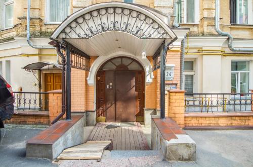 a building with a wooden door and a wooden bench at Cheap Apartments in Kyiv