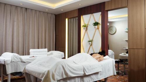 a woman laying in a hospital bed in a room at Kempinski Hotel Khan Palace in Ulaanbaatar