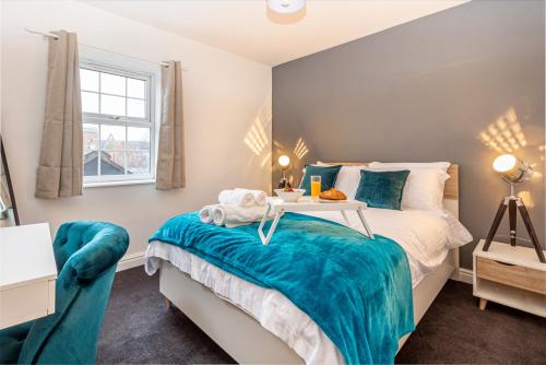 a bedroom with a bed and a table and a window at Guest Homes - New Street Apartment in Worcester