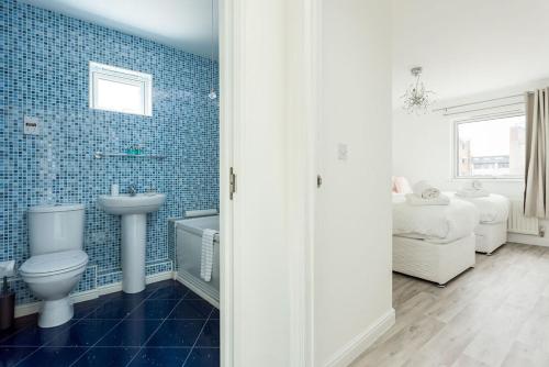 a bathroom with a toilet and a sink at Beach Point in Poole