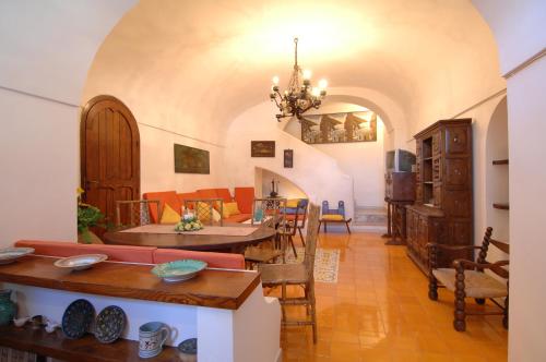 a living room with a couch and a table at Casa Bouganville in Positano