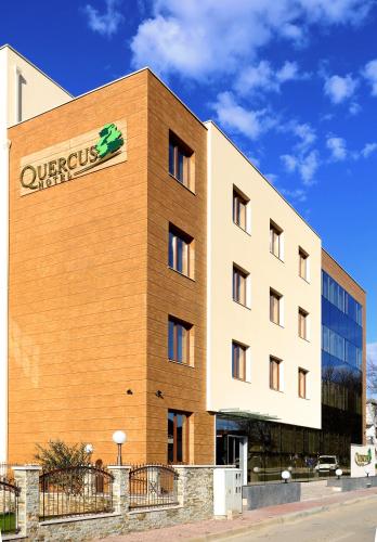 a building with a sign on the side of it at Hotel Quercus in Međugorje