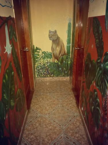 a painting of a cat sitting on a wall at Hostal Casa Del Inka in Cusco