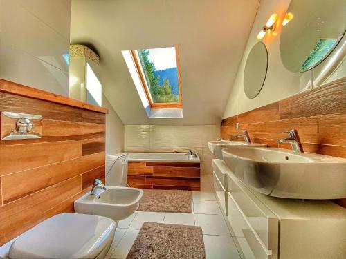 a bathroom with a sink and a toilet and a tub at Willa Pod Skocznią in Szczyrk